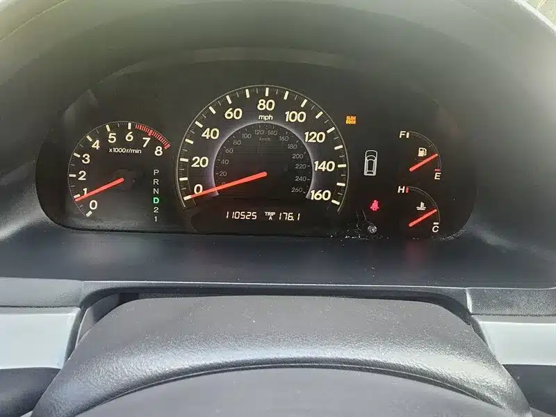 Interior of a used 2010 Honda Odyssey EX-L showing gray leather seating, dashboard with infotainment system, and spacious cabin, for sale in Spring, TX.