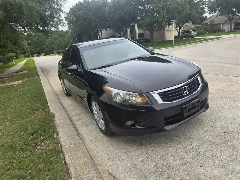 Black Honda Accord, front three-quarter view
